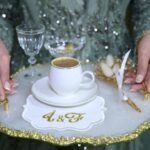 A woman holding a tray with a cup and a plate