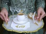 A woman holding a tray with a cup and a plate