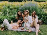 Women Sitting on Green Grass Field