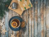 A cup of tea and a christmas tree on a wooden table