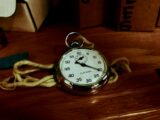 White Pocket Watch With Gold-colored Frame on Brown Wooden Board