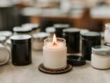 Close-up of a Burning Candle among Black and White Candles Standing on the Table