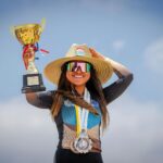 Smiling Sportswoman with Medals and Golden Trophy