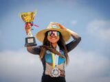 Smiling Sportswoman with Medals and Golden Trophy