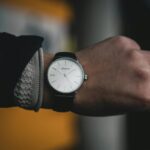 Person Wearing Round White Analog Watch at 10:09