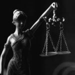 A Grayscale of a Lady Justice Figurine