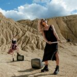 Blonde Women with Sunglasses Posing on Desert with Sledgehammer