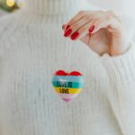 Close-Up Shot of a Person Holding a Heart-Shaped Keychain