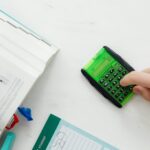 Person Using A Green and Black Calculator