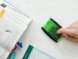 Person Using A Green and Black Calculator