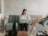 Woman Drinking Coffee While Working With Laptop