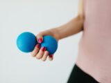 Faceless young woman with stress ball on white background