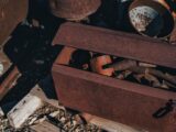 A rusty box with a bunch of rusty tools