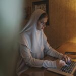 Woman in White Hijab Using Laptop Computer