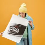 Woman Looking at the Banner she is Holding