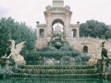 Aged masonry construction with animal sculptures and fountain with stairs in Citadel Park of Barcelona Spain